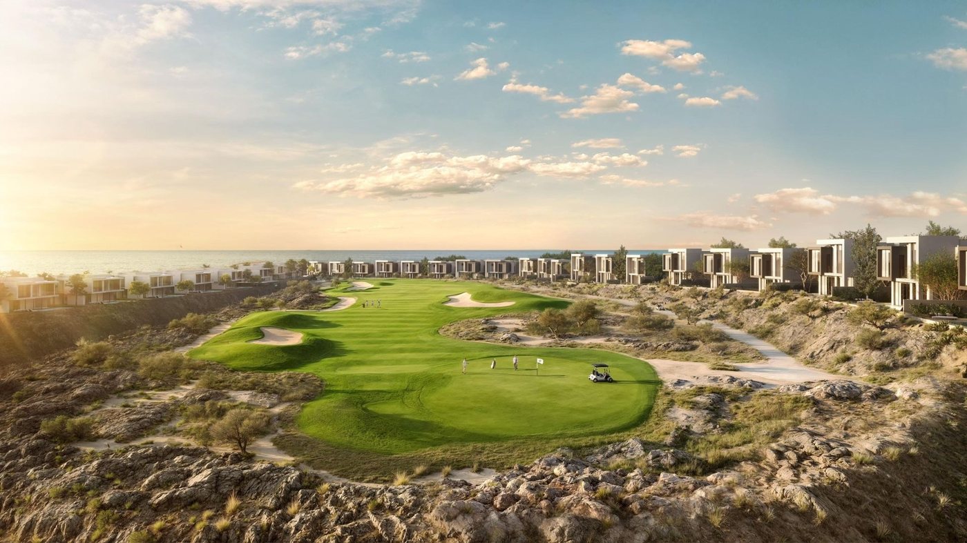 Golf course with villas on the clifftop at sunset